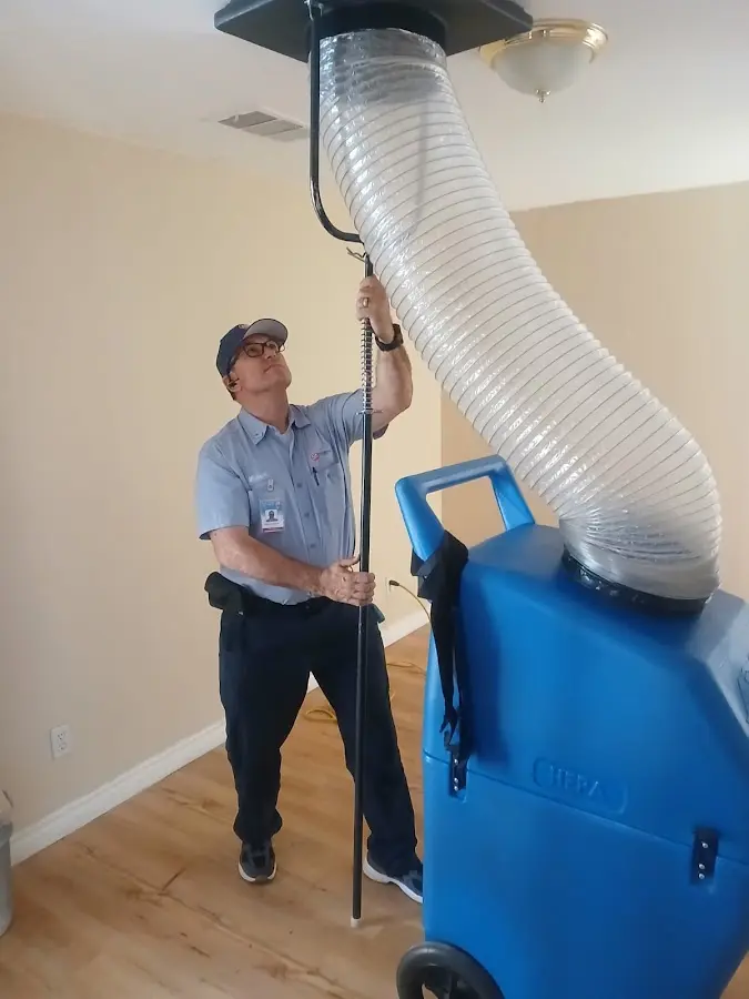Furnace Tune-Up technician using HEPA equipment in Riverside